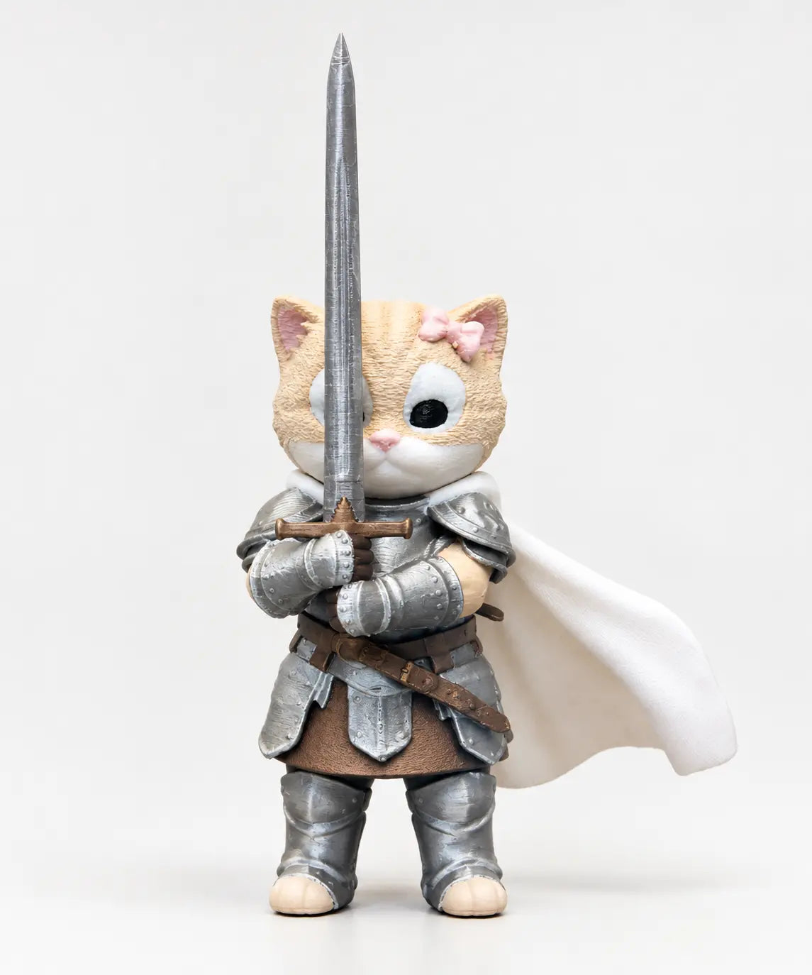 Knight Kitten 3D-printed figurine holding a sword, with silver armor, white cape and pink bow
